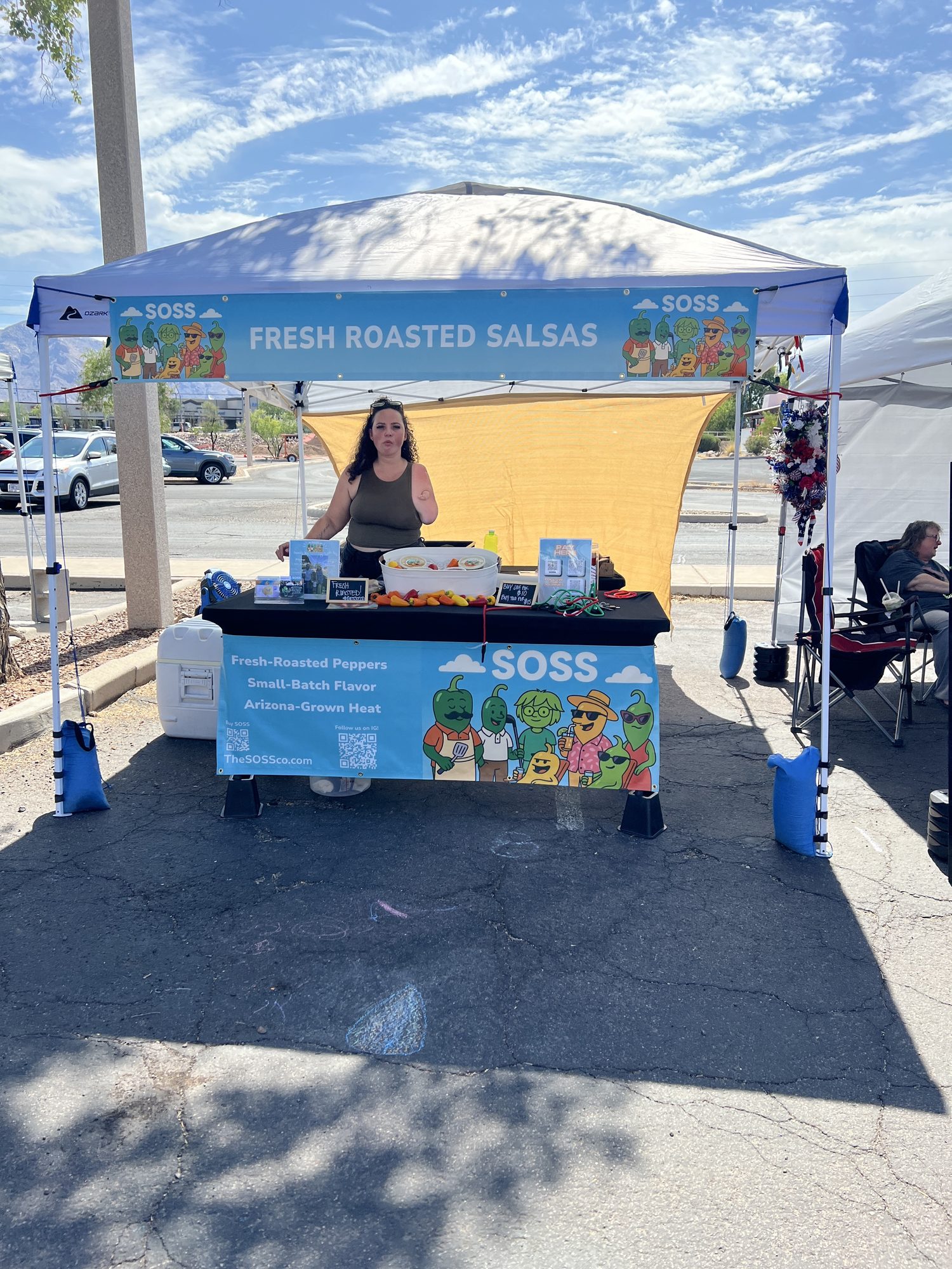 The SOSS Co. market booth with a Fresh Roasted Salsas banner