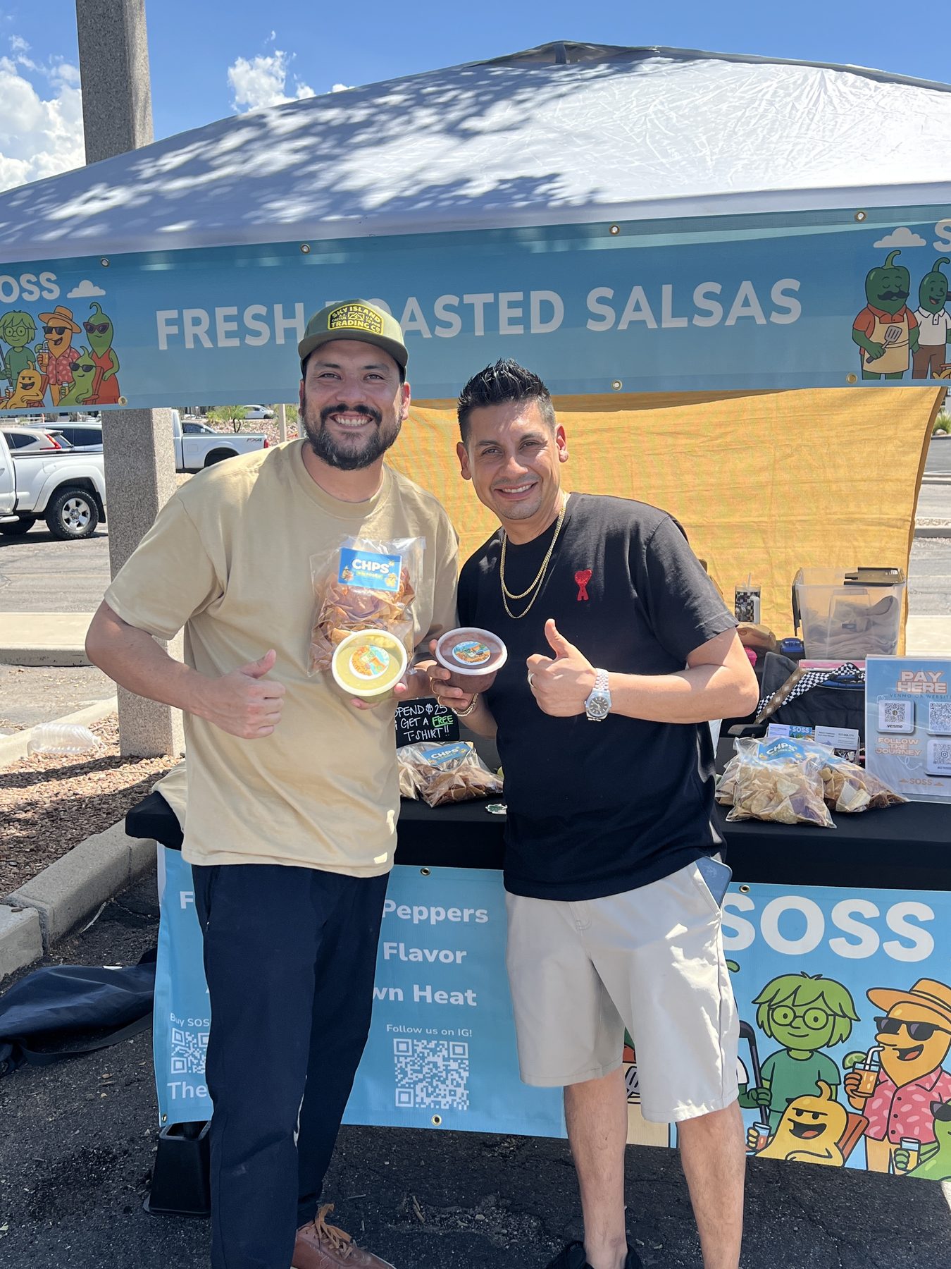 A market customer holding SOSS tubs and CHPS at the booth